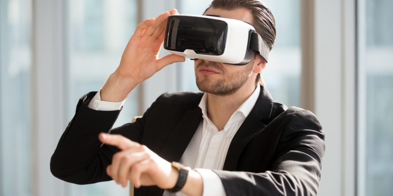man-wearing-vr-headset-and-pointing-at-the-air